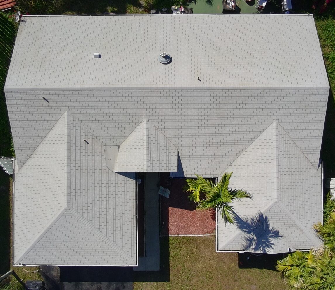Asphalt shingle roof being soft washed in Parkland FL