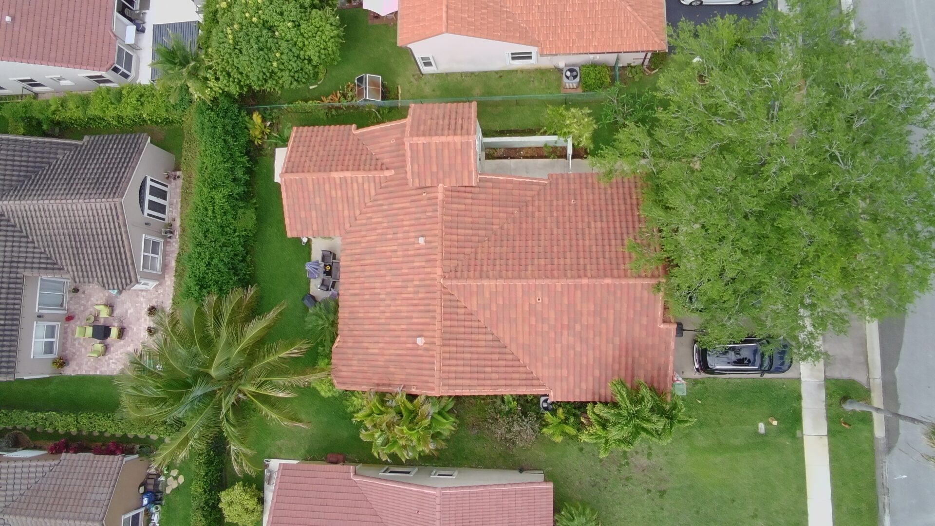 Barrel tile roof being soft washed in Parkland FL
