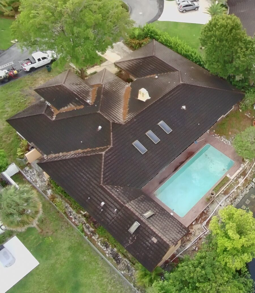 Tile roof with black algae streaks on Parkland estate home before soft wash cleaning